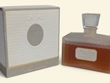 an image of a bottle of perfume sitting next to a box