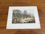 an old print of a dog chasing a cat on a table