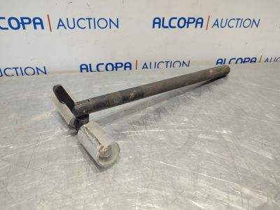 a picture of a metal hammer on a table with a sign in the background