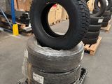 tires stacked on pallets in a warehouse with pallets in the background