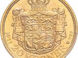a close up of a gold coin with a coat of arms on it