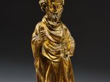 a gold statue of a man with a beard and a robe
