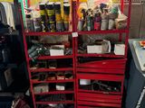 many different types of tools on the shelves in the garage