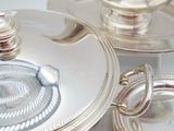 a silver plate with a silver lid and a silver plate with a silver plate with a silver lid and a silver plate with a silver plate with a silver