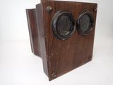 a wooden box with two speakers on it