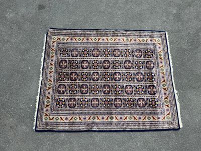 a rug on the ground with a cat laying on top of it