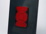 a picture of a picture of a red bear on a black plate