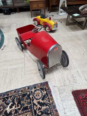a toy car that is sitting on the floor in the living room