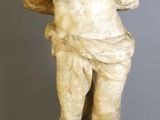 marble statue of a man holding a basket on a pedestal