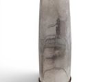 a tall glass vase with a brown base on a white background