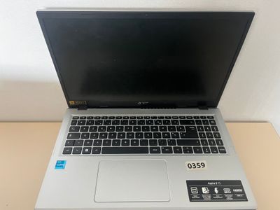 an open laptop computer sitting on top of a wooden table