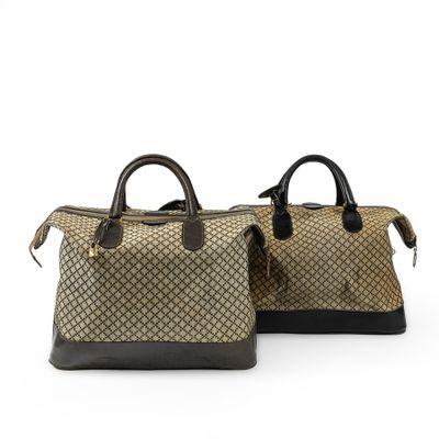 a pair of brown and black handbags sitting on top of each other