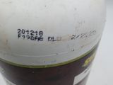 a white bottle with a green cap sitting on a table