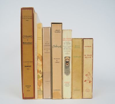 several books are lined up in a row on a white surface