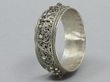 a close up of a silver ring on a gray surface