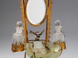 a gold and glass vanity with a mirror on top of it