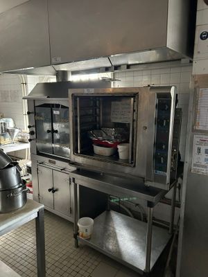a kitchen with a stove, oven, sink, and other appliances