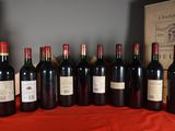several bottles of red wine are lined up on a table