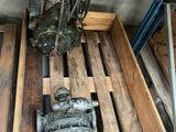 a wooden crate with a pump and other tools on it