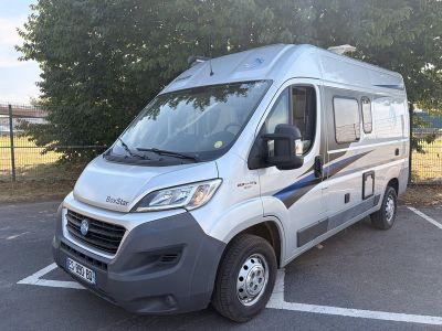 une camionnette argentée garée dans un parking