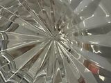 a broken glass plate with a knife and fork in it