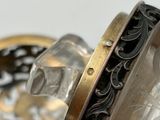 a close up of a glass bottle with a ring on it