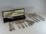 a set of silverware in a wooden box on a table