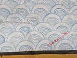 a close up of a painting of waves on a table