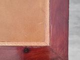 a close up of a wooden frame with a picture on it