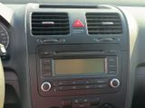 a car dashboard with a radio and a steering wheel