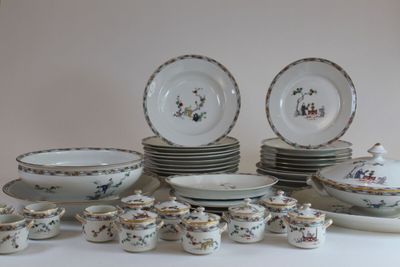 a lot of plates and bowls and cups on the table