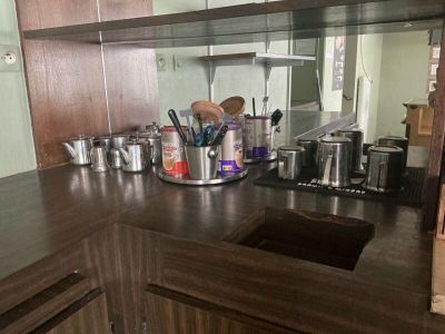 a kitchen counter with a sink and a mirror in it