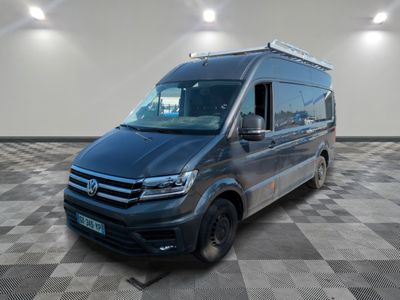 the volkswagen van is parked in a large room with checkered floor