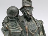 statue of a man holding a child in his arms
