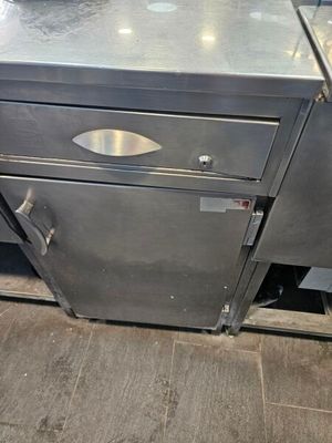 a stainless steel counter top with a metal drawer underneath it