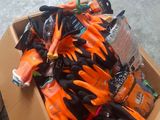 a cardboard box full of orange and black gloves