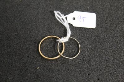 two rings on a black surface with a price tag