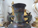 a vase that is sitting on a table next to other vases