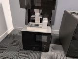 a coffee machine sitting on top of a table next to a refrigerator