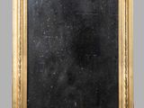 an antique gold framed mirror with a black background