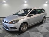 the silver ford focus is parked on a checkered tile floor