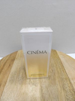 a close up of a box of perfume on a wooden table