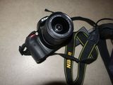 a camera that is sitting on a table next to a camera strap