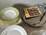 a table with plates, cups, and a box of chocolates on it