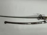 two swords on a white surface with a black handle