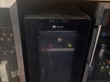 a small refrigerator with a wine cooler inside of it