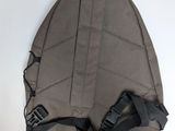 the back of a backpack hanging on a white wall