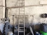 a ladder that is leaning against a wall in a garage