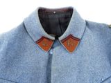 a close up of a blue coat with a leather collar
