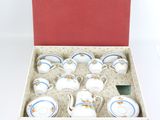 a red box with tea cups and saucers in it